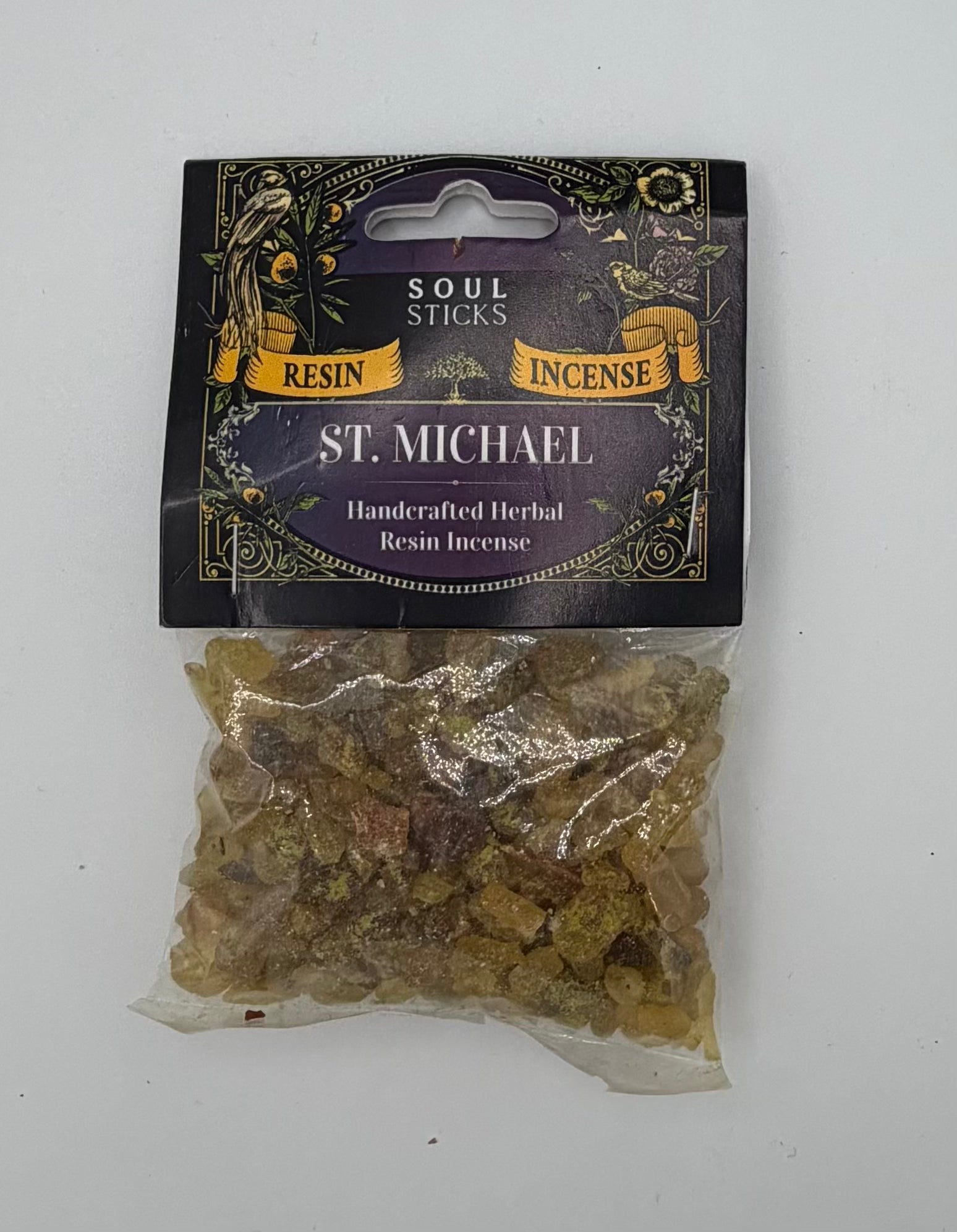 A clear plastic bag containing amber-colored resin incense sticks, sealed under a black and gold cardboard header card labeled 'SOUL STICKS RESIN STICKS INCENSE St. Michael Handcrafted Herbal Resin Incense'.